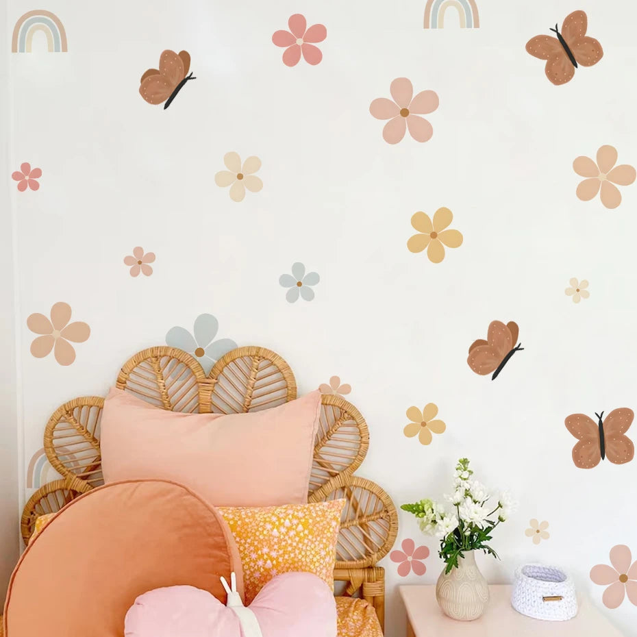 Decorative wall with floral and butterfly patterns, wicker chair with colorful cushions, and small table with flowers.