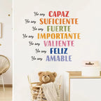 Wall with motivational Spanish phrases and a teddy bear in a basket.