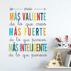 Colorful motivational quote on a white wall with decorative items below.