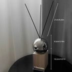 Silver diffuser with measurement labels on a neutral background