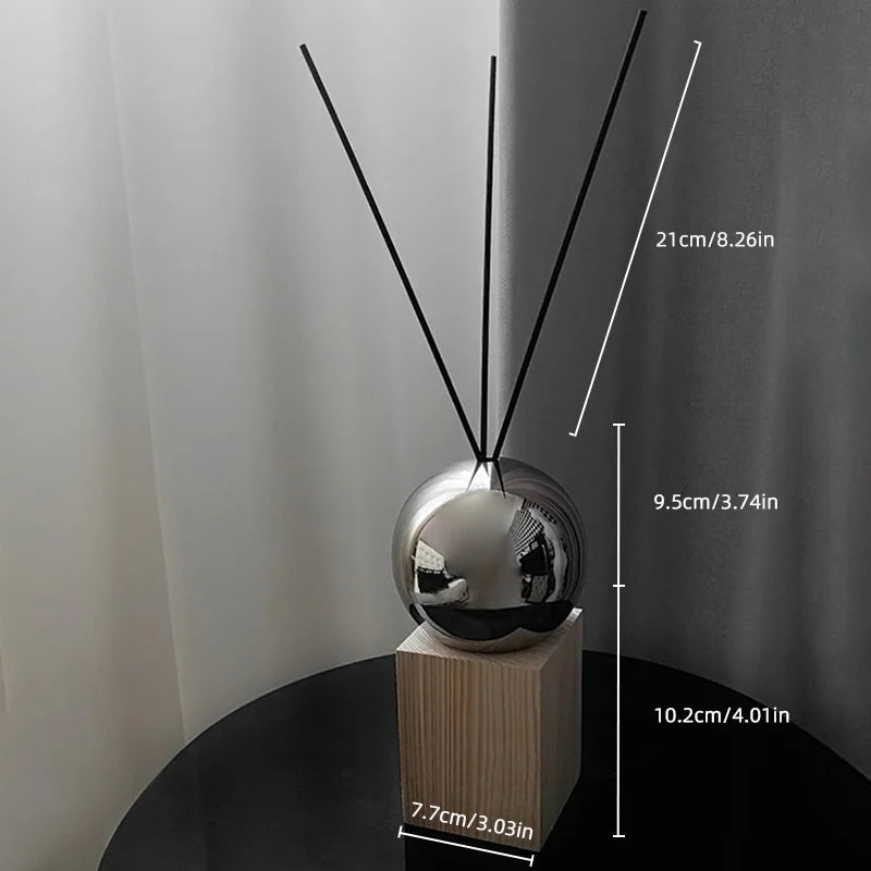 Silver diffuser with measurement labels on a neutral background