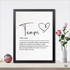 Framed print with the word 'Team' and its definition on a white wall with decorative items.