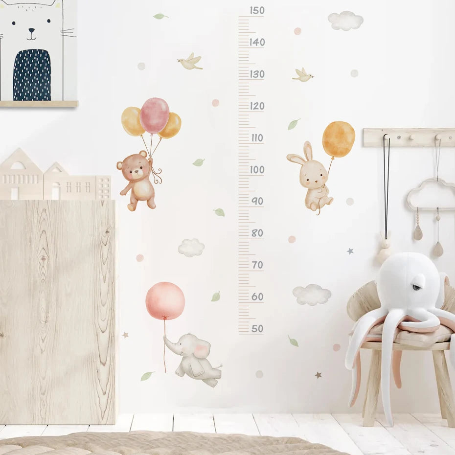 Children's room with decorative wall stickers of animals with balloons and a height chart.