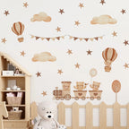 Children's room with decorative wall stickers of teddy bears on a train, hot air balloons, and clouds.
