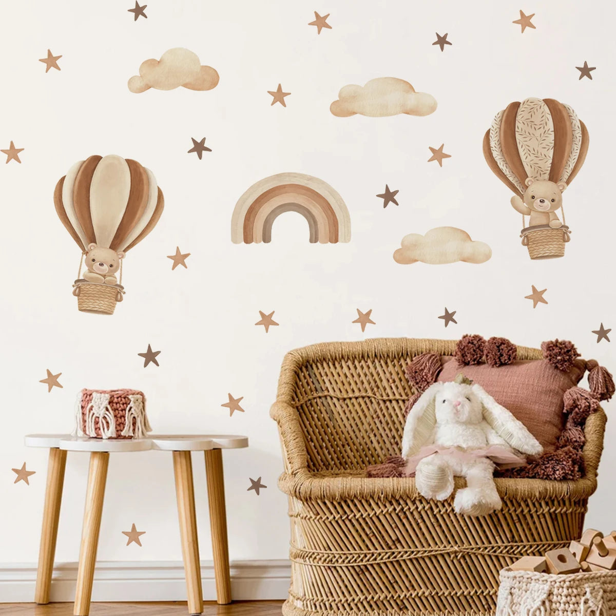 Children's room with wicker chair, teddy bear hot air balloon wall decals, and wooden table.