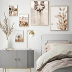 Decorative bedroom with framed artwork on the wall and a bed with beige bedding.