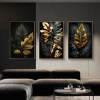 Three framed leaf artworks on a wall above a sofa