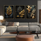Living room with a gray sofa, wooden coffee table, and three framed leaf art pieces on the wall.