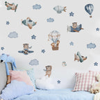 Children's room with airplane and teddy bear wall decals on a light blue wall.