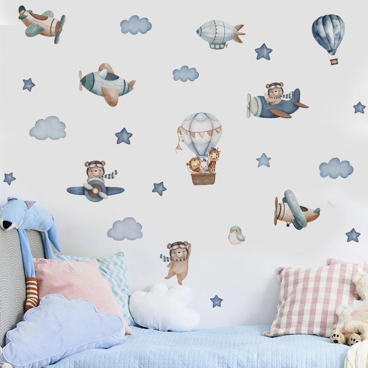Children's room with airplane and teddy bear wall decals on a light blue wall.