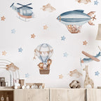 Children's room with wall stickers of airplanes, hot air balloons, and animals on a light blue background.