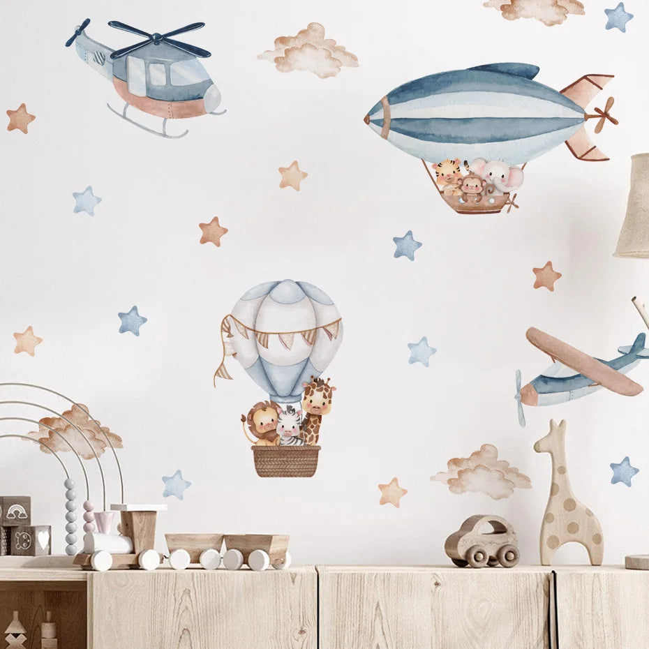 Children's room with wall stickers of airplanes, hot air balloons, and animals on a light blue background.