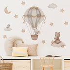 Children's room with wall decals of a hot air balloon, teddy bear, and stars.