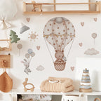 Nursery room with wall decals of a teddy bear in a hot air balloon, balloons, and clouds.