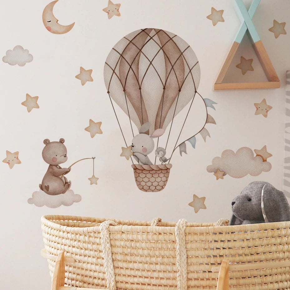 Children's room with wall decals of a hot air balloon, teddy bear, and clouds.