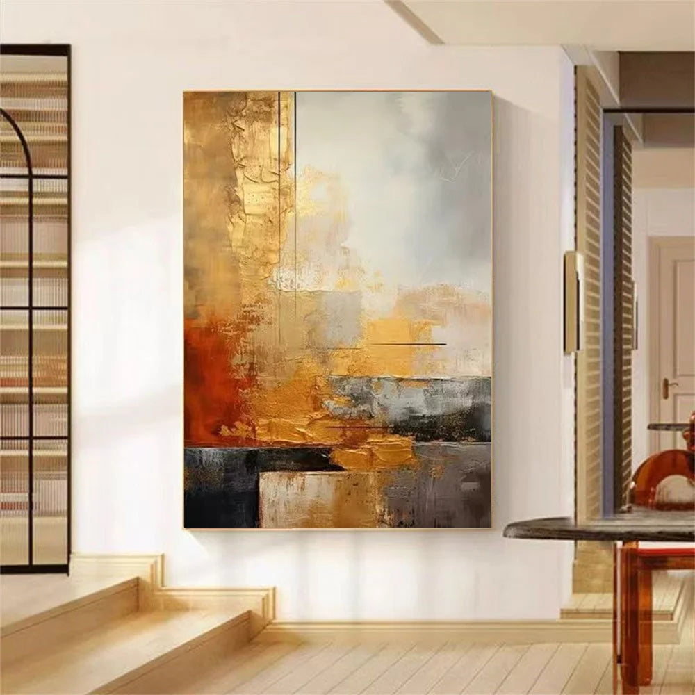 Abstract painting with gold, brown, and gray tones in a modern interior setting.