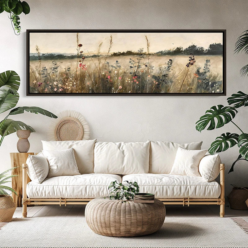 Living room with a white sofa, woven coffee table, and framed nature print on the wall.