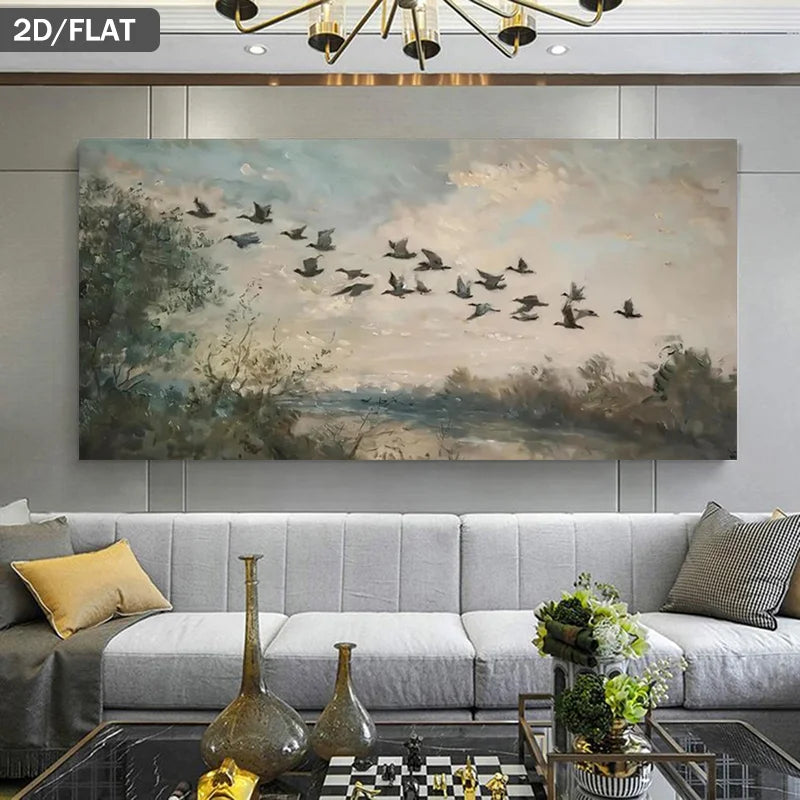 A large rectangular wall art print showing a flock of birds flying over a soft landscape, displayed above a light gray sofa in a modern living room. The print has a muted palette of beige, blue-gray, brown, and black.