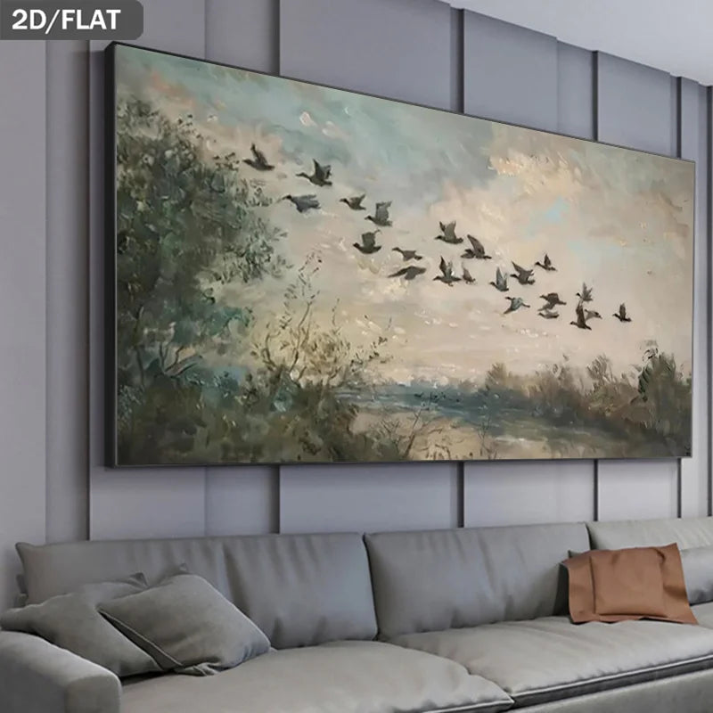 A large rectangular wall art piece showing a soft landscape painting with flying birds, displayed above a gray sofa in a modern living room setting.