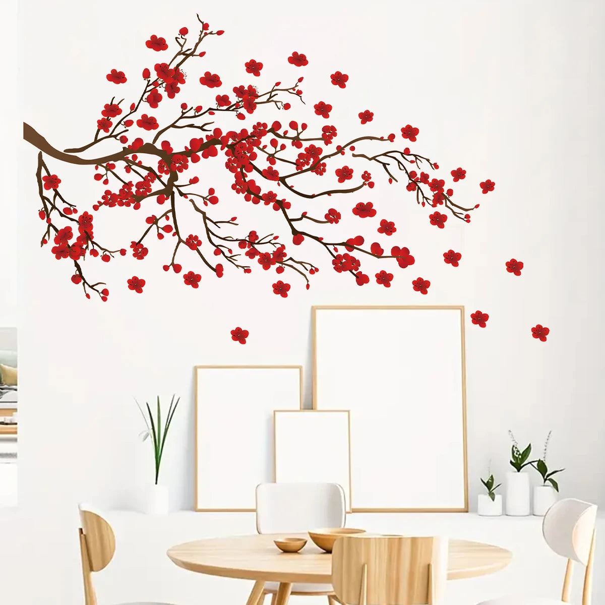 Red floral wall decal on a white wall with a dining table and chairs in the foreground.