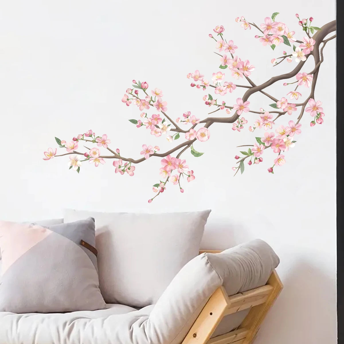 Floral wall decal on a white wall above a sofa with cushions.