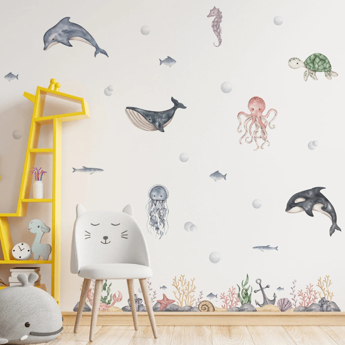 Children's room with ocean-themed wall decals, yellow shelf, and white chair.