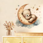 Illustration of a bear sleeping on a crescent moon with stars and clouds in a room setting.