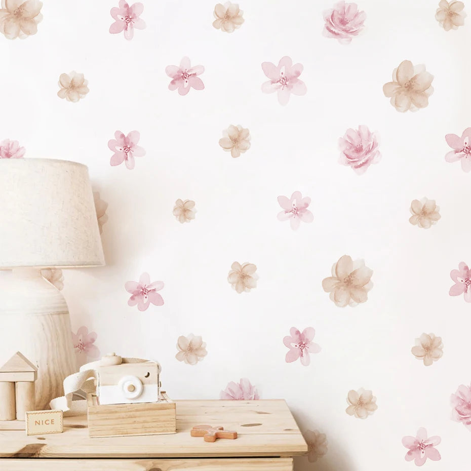 Floral wallpaper with pink flowers on a white wall, featuring a lamp and wooden toys.