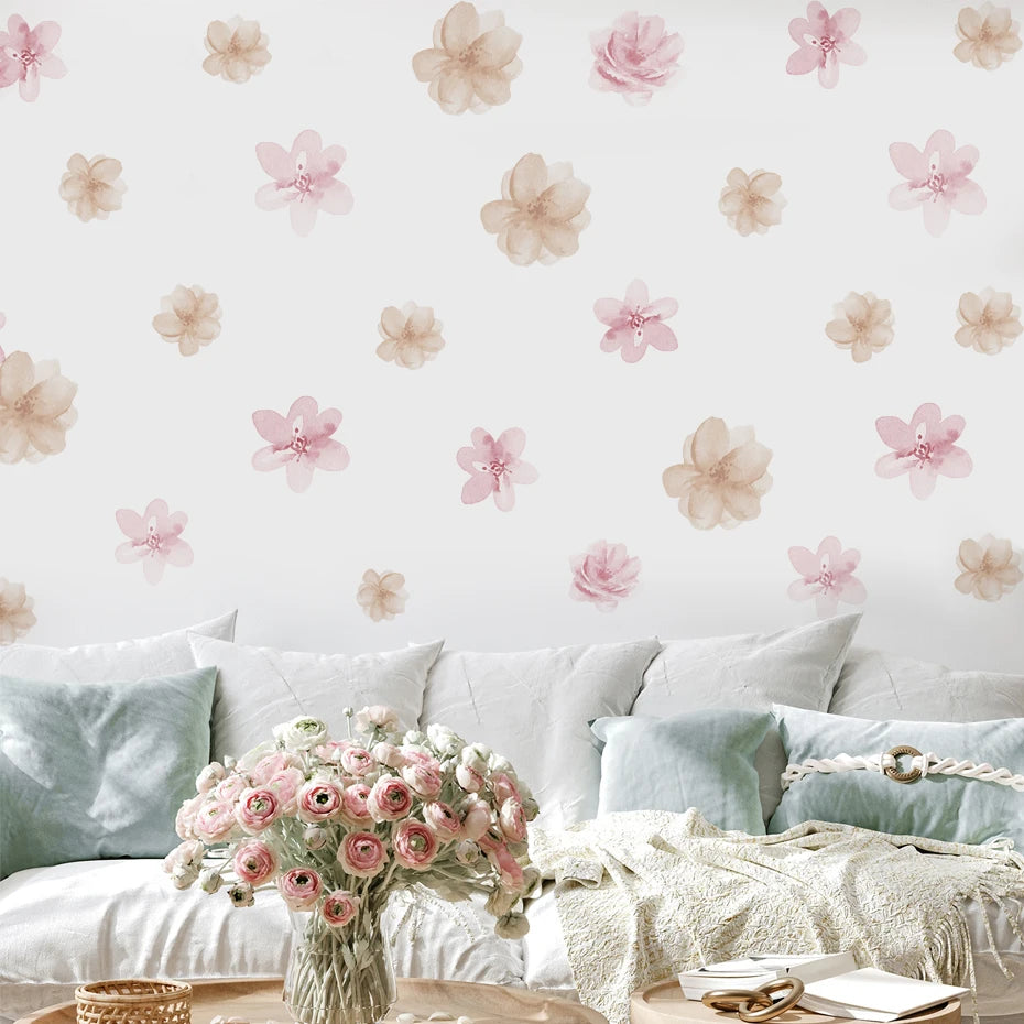 Floral wallpaper with pink and beige flowers on a light background, featuring a sofa with light blue pillows and a vase of flowers.