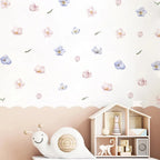 Children's room with a toy house, plush snail, and floral wall decals.