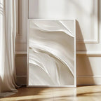 Framed abstract artwork on a wall with soft lighting