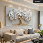 Decorative wall art of a tree with white flowers and gold branches in a living room setting.