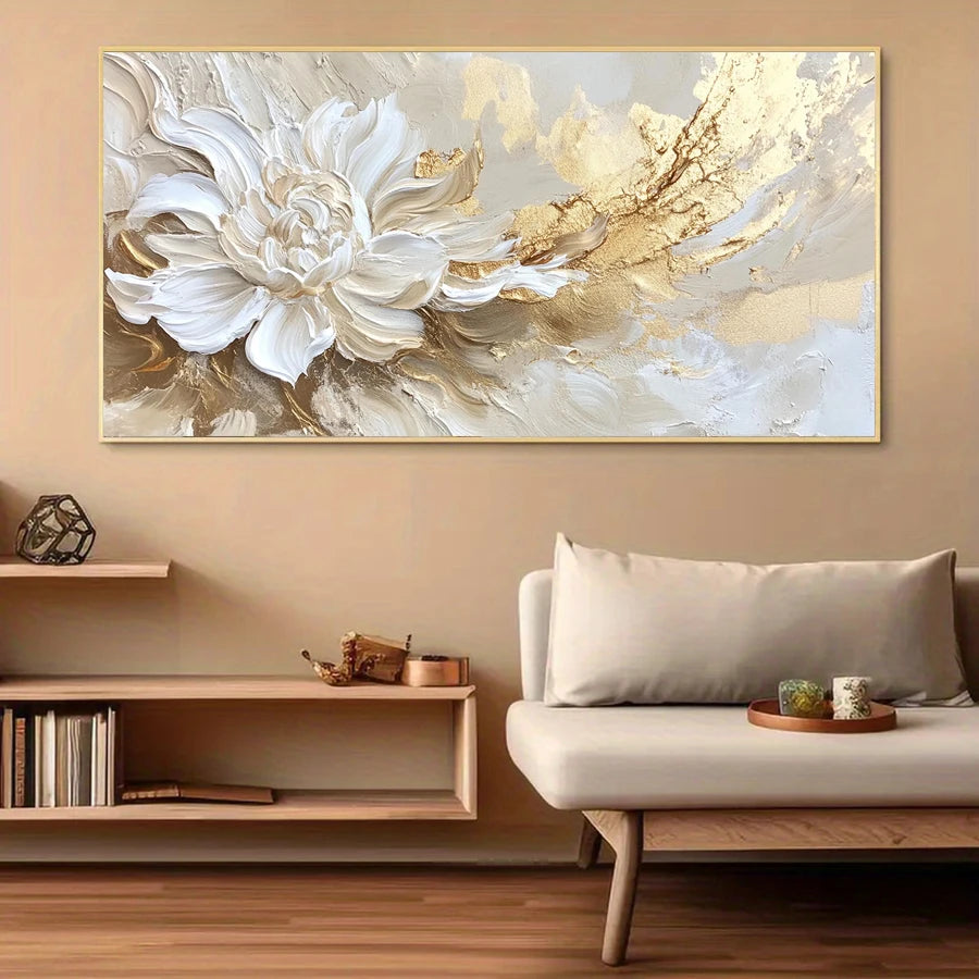 Abstract painting of a white flower with gold accents on a beige wall above a sofa and shelf.
