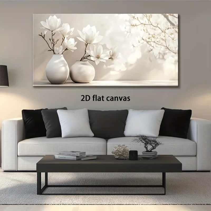 A large rectangular canvas wall art print showing white magnolia flowers in two white vases, displayed above a modern white sofa in a styled living room. The text '2D flat canvas' appears below the artwork.