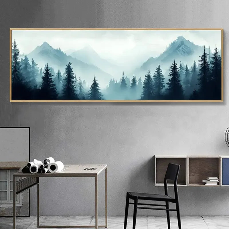 Framed artwork of a mountain landscape with trees on a gray wall above a desk and chair.