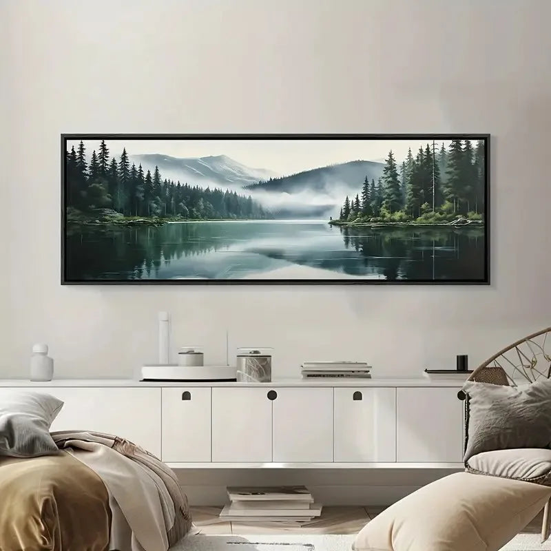 Framed nature landscape of a lake and trees on a wall in a living room.