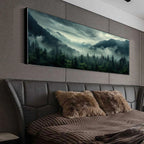 Large wall art of a forest scene above a bed with brown pillows.