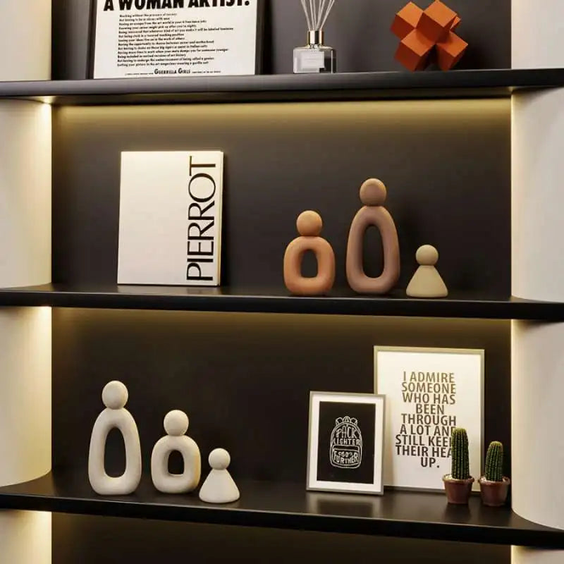 Decorative shelves with ceramic figures, framed art, and small plants.