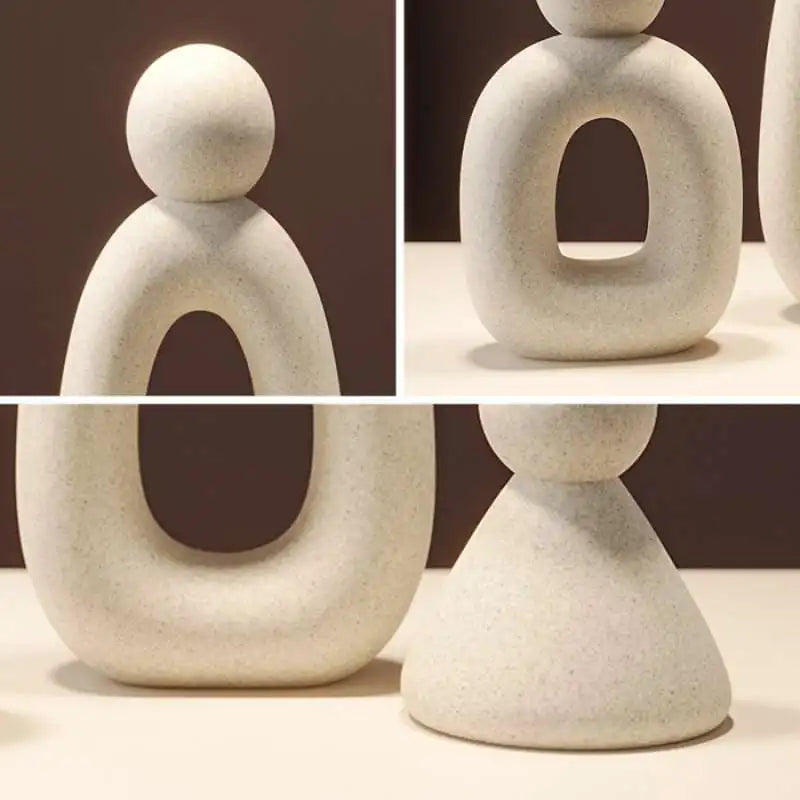 Abstract stone sculpture with rounded forms on a neutral background